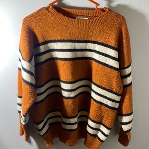 French, M/L sweater. A comfortable orange, white and black material.